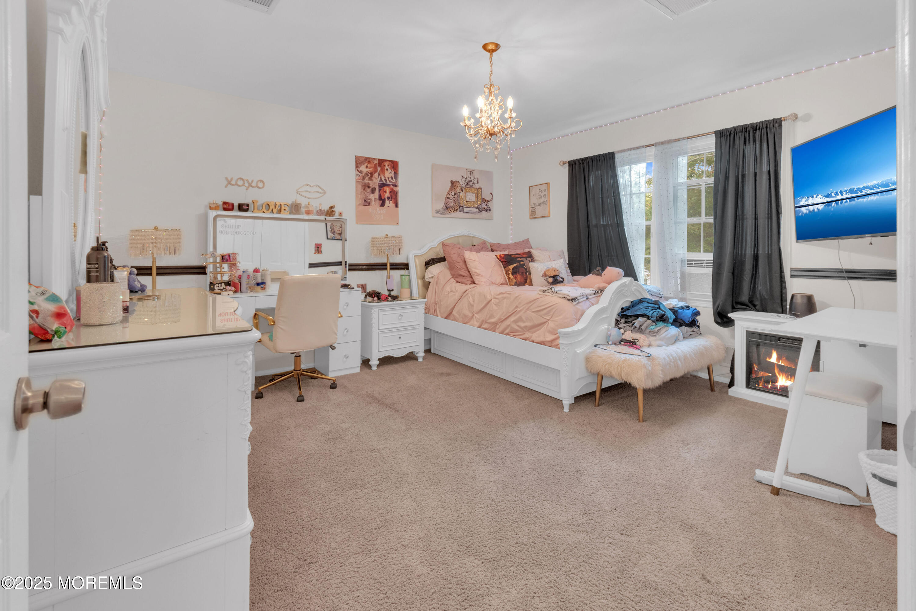 41 Longstreet Road Manalapan, NJ 07726 - Photo 21 of 51 a bed room with furniture and a chandelier