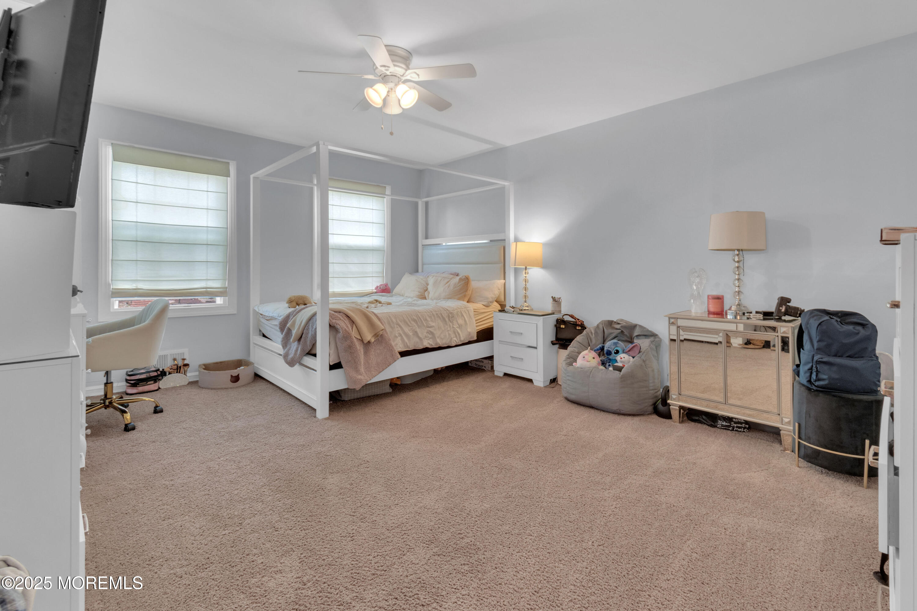 41 Longstreet Road Manalapan, NJ 07726 - Photo 22 of 51 a spacious bedroom with a bed and a chandelier