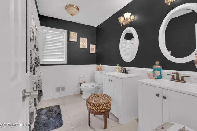 a bathroom with a double vanity sink and a mirror