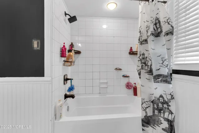 a bathroom with a bathtub and shower