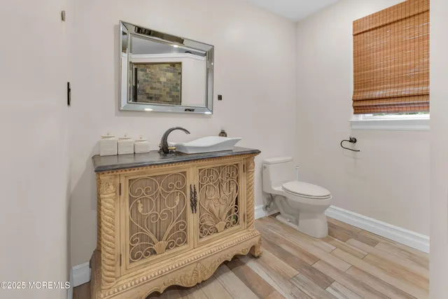 a bathroom with a toilet a sink and a window