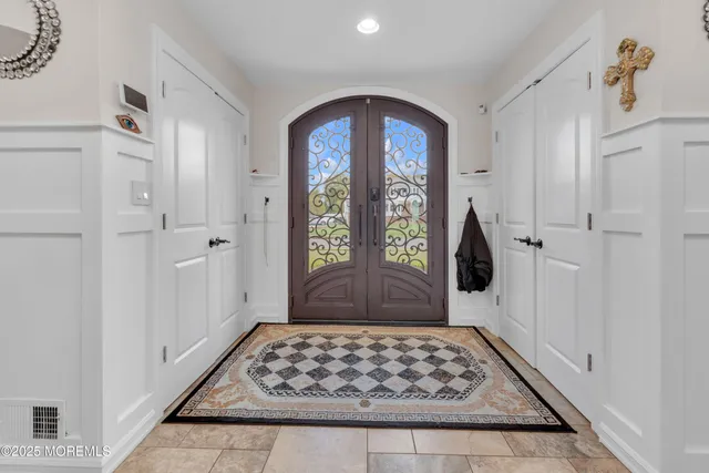 a view of a hallway with wooden floor and a window