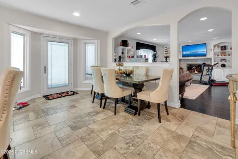a view of a a dining room with furniture window and wooden floor