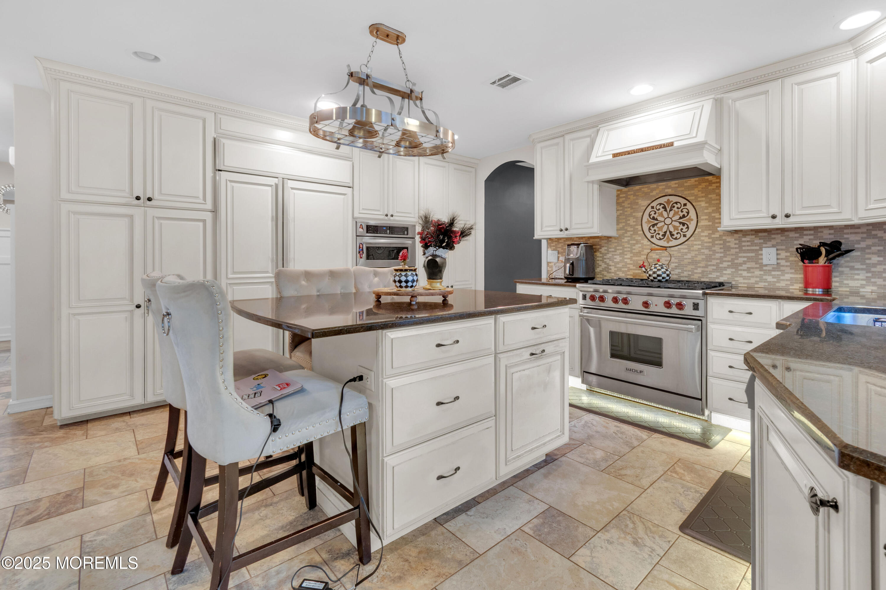 41 Longstreet Road Manalapan, NJ 07726 - Photo 9 of 51 a kitchen with white cabinets and stainless steel appliances