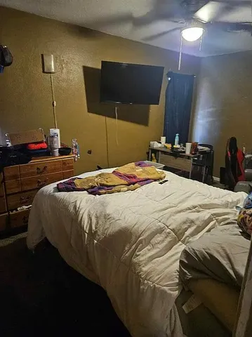 a bedroom with a bed and a night stand