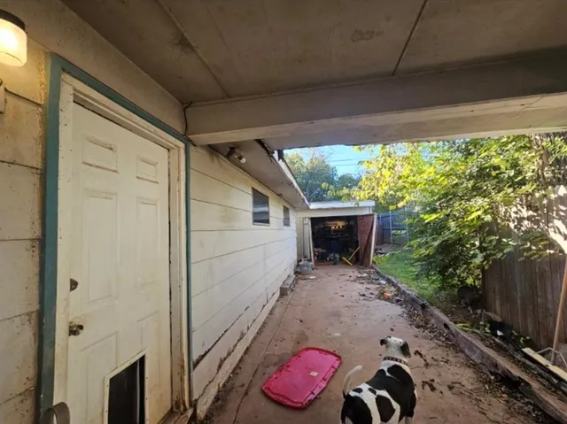 a backyard of a house with table and chairs