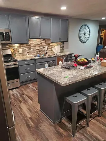 a kitchen with a stove a refrigerator and a table