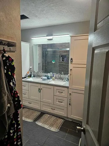 a bathroom with a sink and mirror