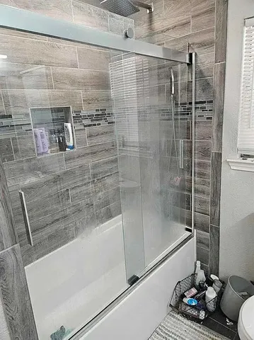 a bathroom with a shower and a bathtub