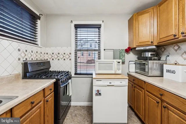 a kitchen with stainless steel appliances granite countertop a stove and a sink