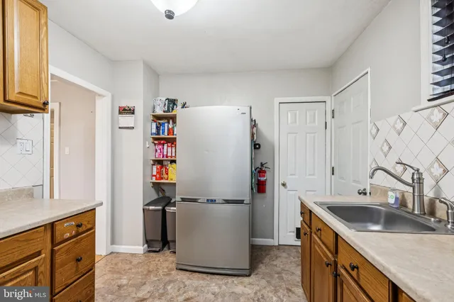 a kitchen with refrigerator sink and cabinets