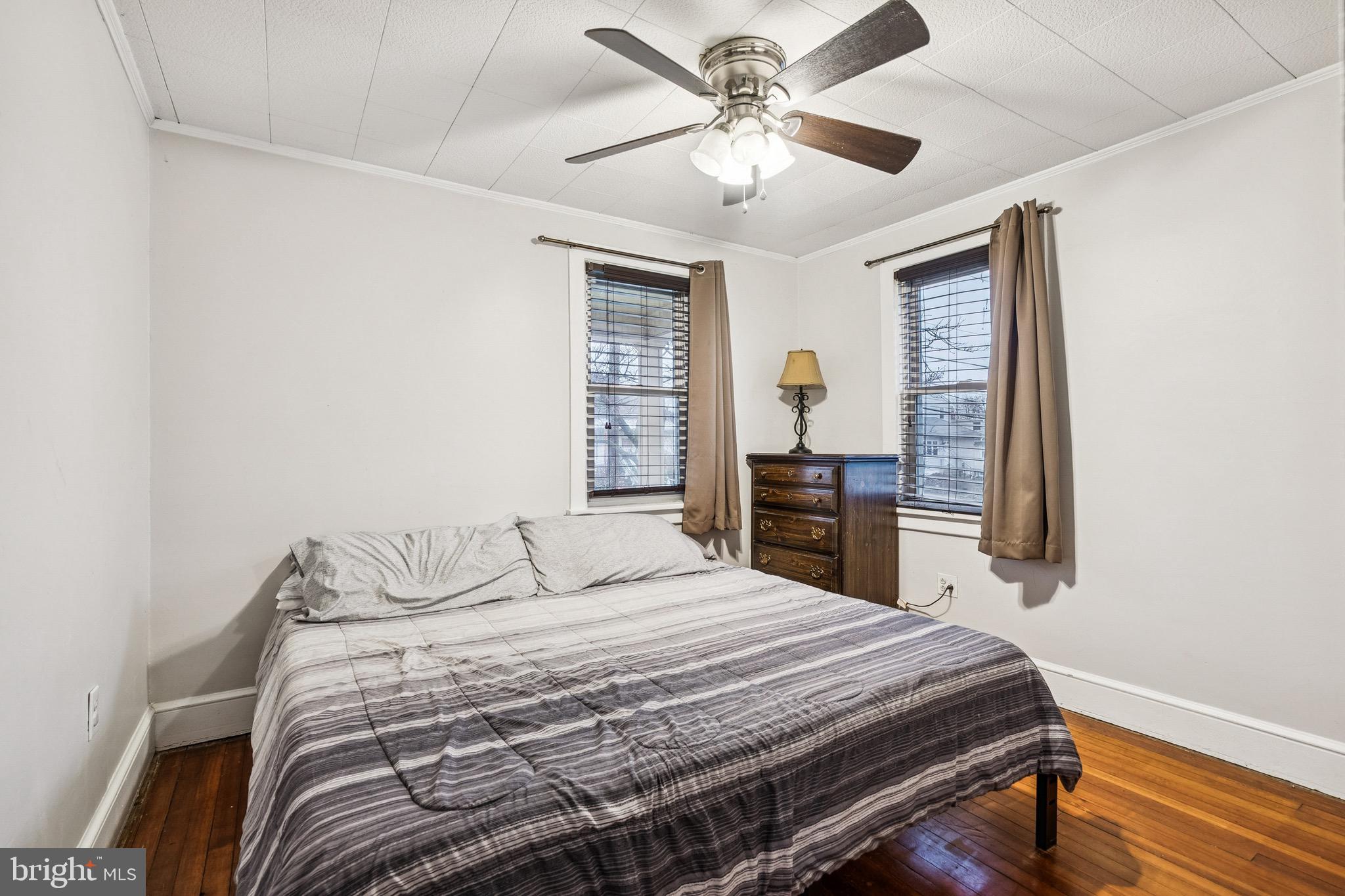 202 South Cedar Avenue Maple Shade, NJ 08052 - Photo 15 of 25 a bedroom with a large bed and a chandelier