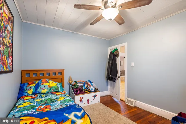 a bedroom with a bed and a book shelf