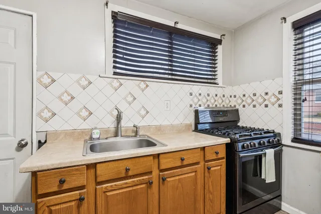 a kitchen with stainless steel appliances a sink and a stove