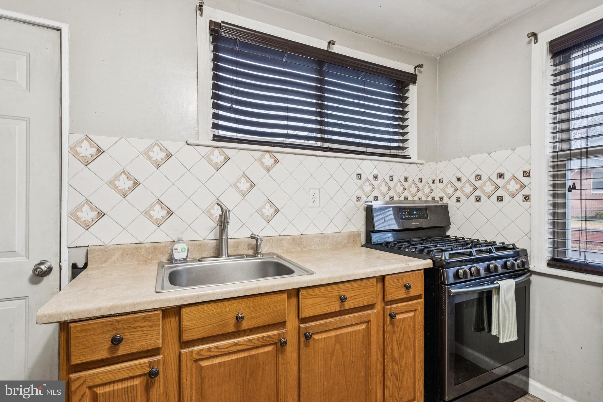 202 South Cedar Avenue Maple Shade, NJ 08052 - Photo 10 of 25 a kitchen with stainless steel appliances a sink and a stove