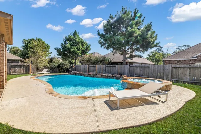a view of a swimming pool with a yard