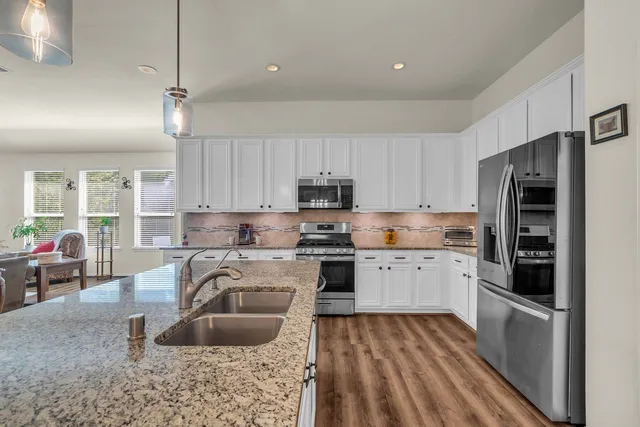 a large kitchen with a table and chairs in it