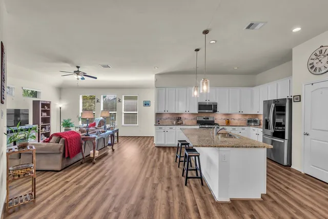 a view of a a dining room with furniture and wooden floor