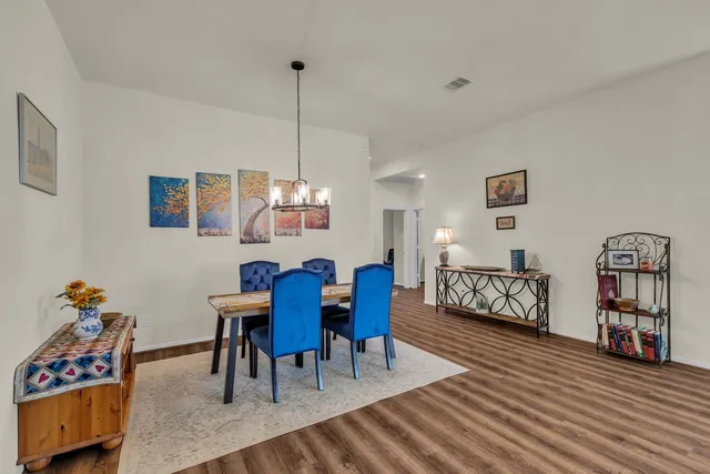 a living room with furniture kitchen view and a large window