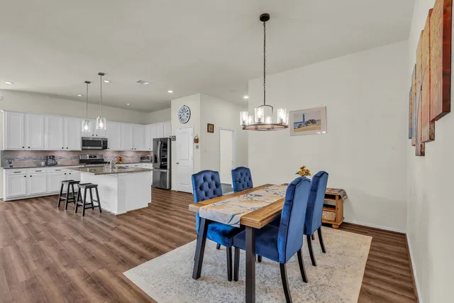 a bedroom with furniture and a wooden floor
