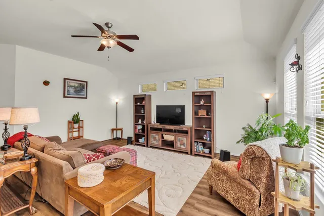 a living room with furniture and a wooden floor