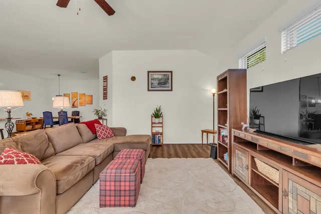 a view of a backyard with swimming pool and sitting area