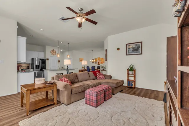 a view of a backyard with swimming pool and wooden fence