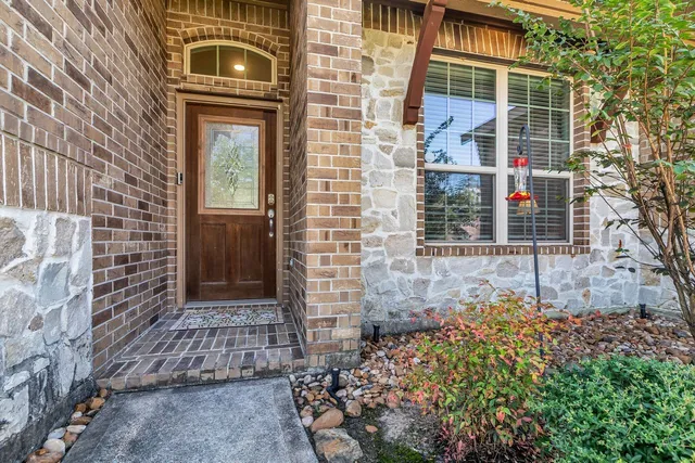 a view of a hallway with wooden floor and closet