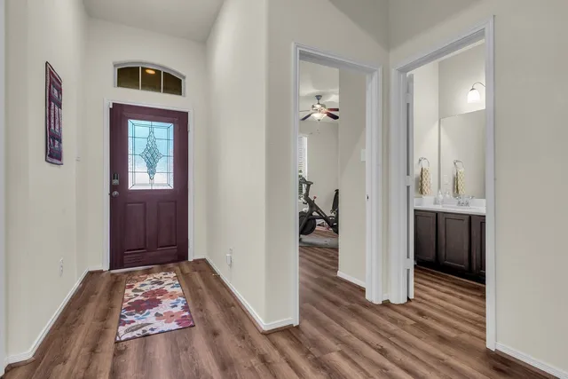 a living room with furniture a rug and a window