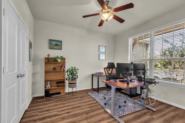 a bathroom with a granite countertop toilet sink and mirror
