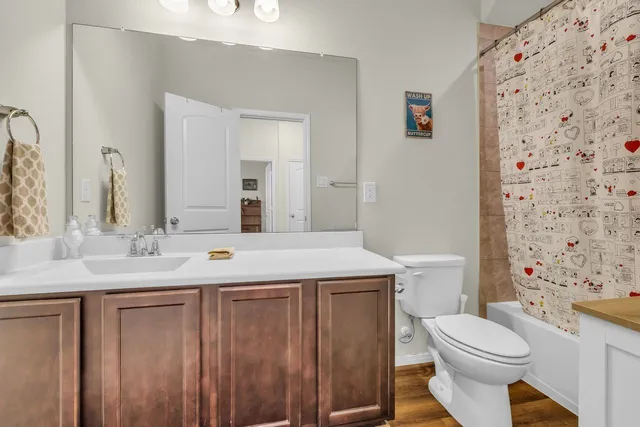 a large kitchen with granite countertop a stove top oven a sink a counter space and cabinets