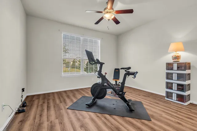 a kitchen with stainless steel appliances a stove top oven a sink dishwasher and a refrigerator with wooden floor