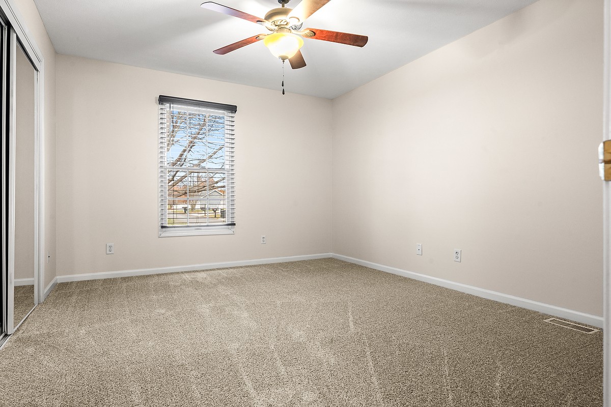 1005 Perry Lane Normal, IL 61761 - Photo 11 of 21 an empty room with windows and fan