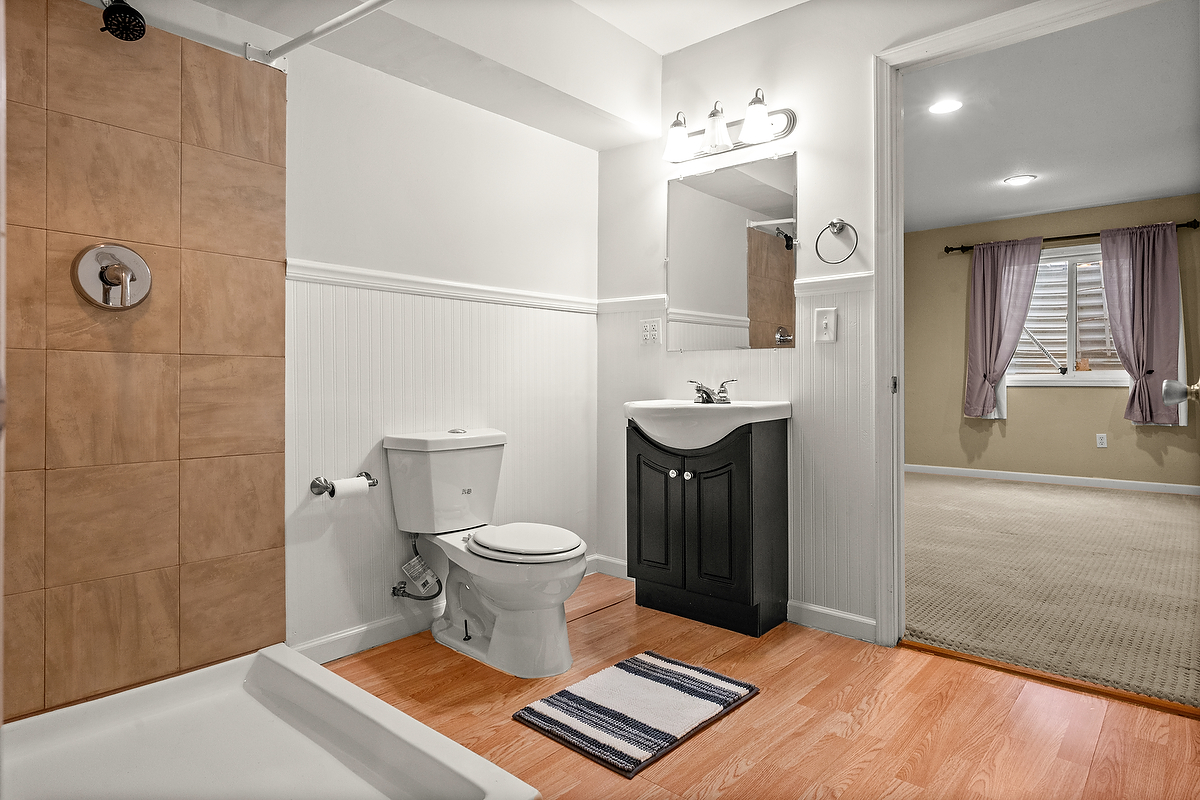 1005 Perry Lane Normal, IL 61761 - Photo 18 of 21 a bathroom with a toilet a sink and mirror