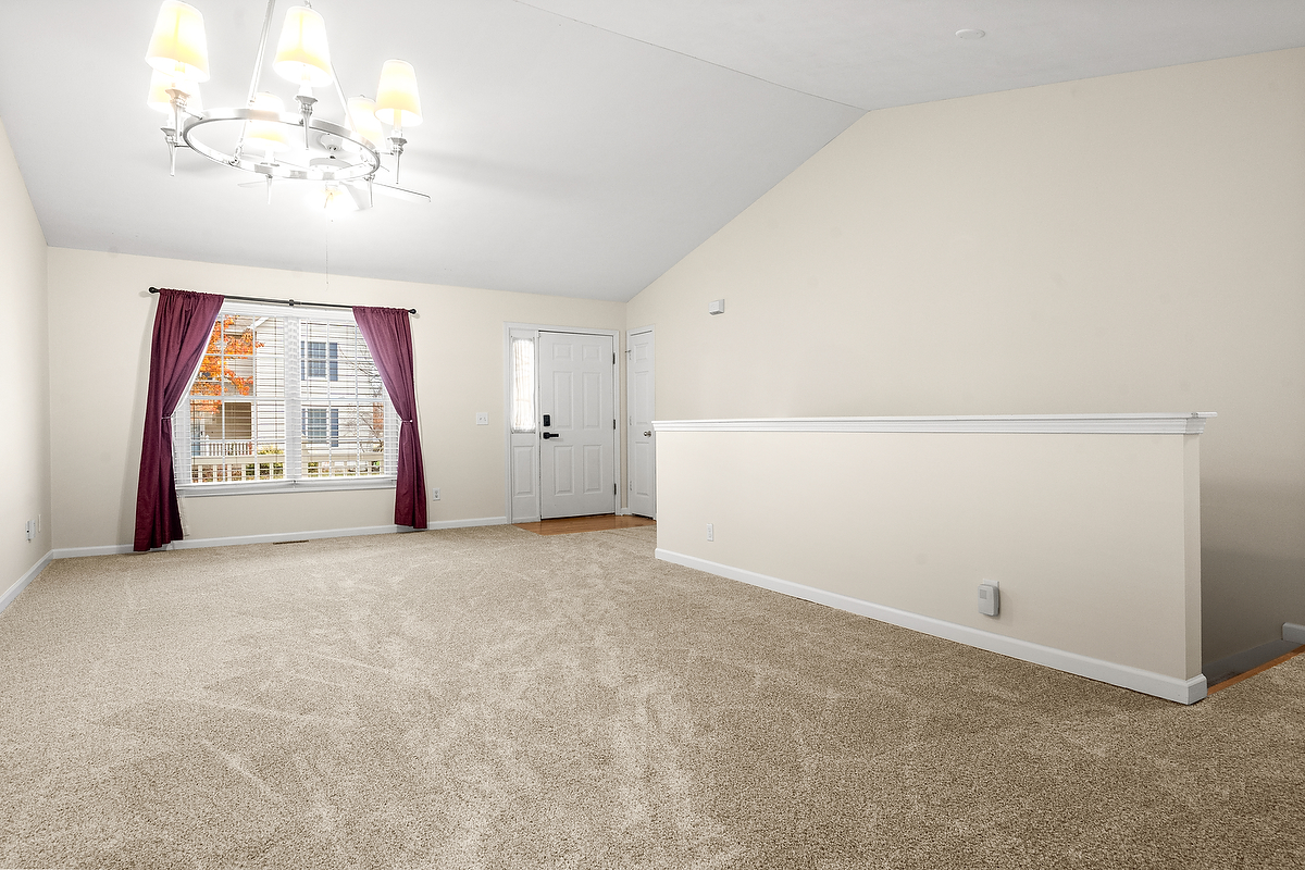 1005 Perry Lane Normal, IL 61761 - Photo 4 of 21 an empty room with a chandelier fan and windows