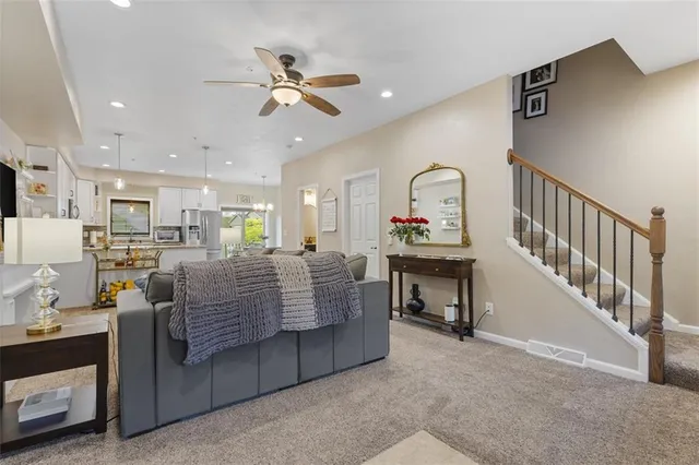 a living room with furniture and a chandelier