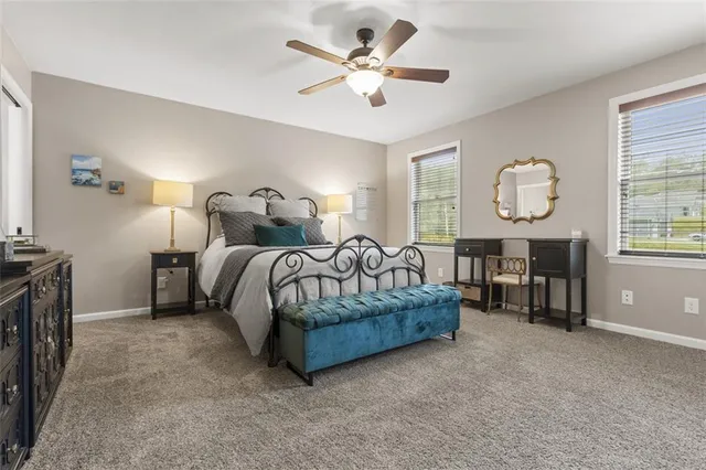 a spacious bedroom with a bed and a chandelier