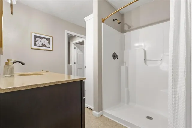 a bathroom with a toilet sink vanity and mirror