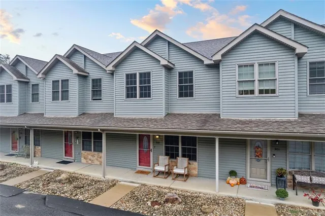 a front view of a house with a yard and a garage