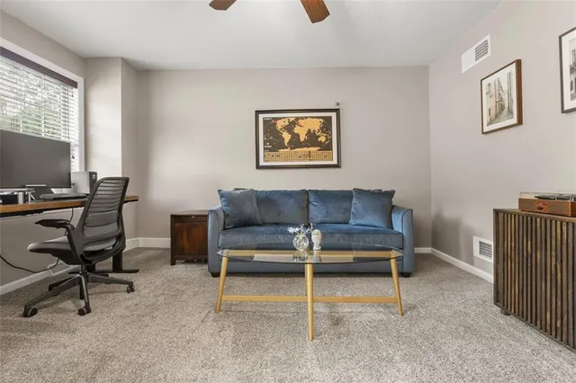 a view of a livingroom with furniture and a ceiling fan