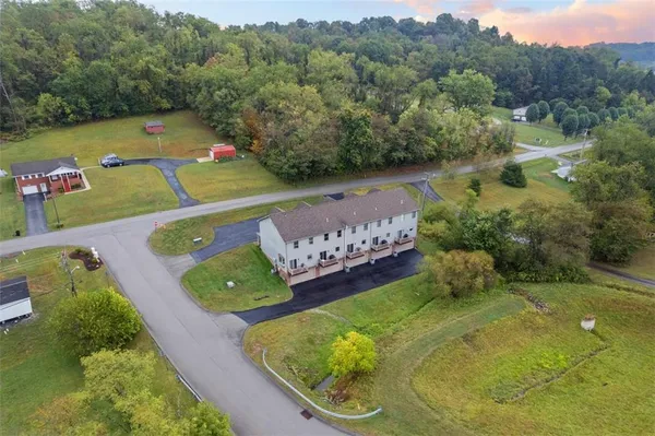 an aerial view of a golf course with parking space
