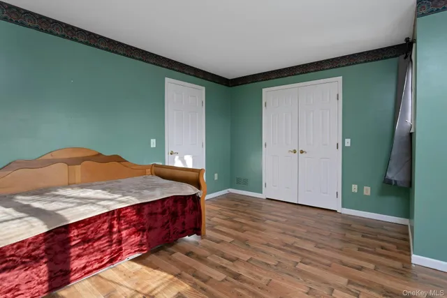 a bedroom with a bed and a dresser