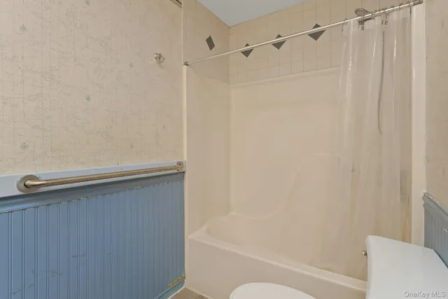 a bathroom with a shower curtain and a bathtub