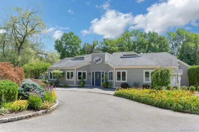 a front view of a house with a garden