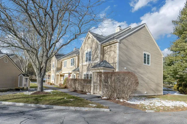 a view of a house with a yard and garage