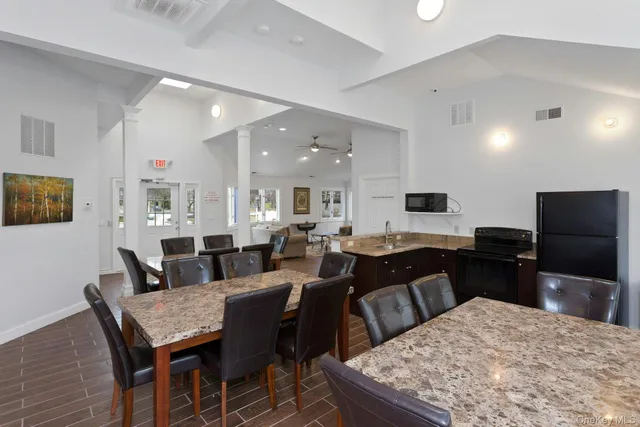 a large kitchen with a table and chairs