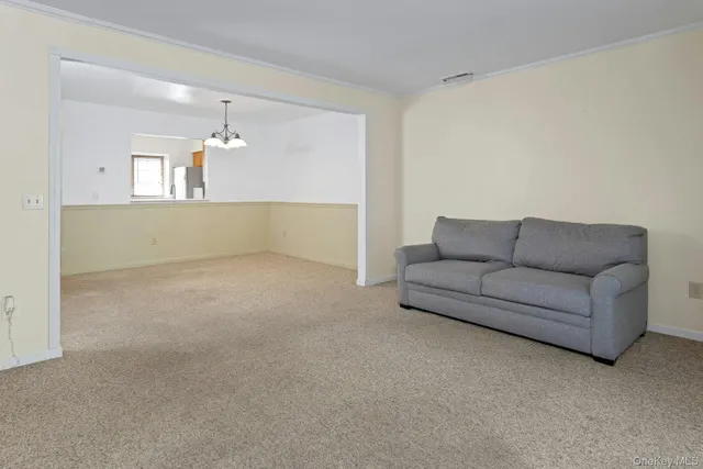 a living room with furniture and a ceiling fan
