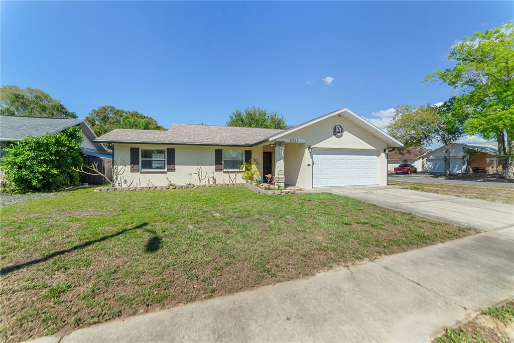 8715 Huntsman Lane Port Richey, FL 34668 - Photo 3 of 54 a front view of a house with a yard