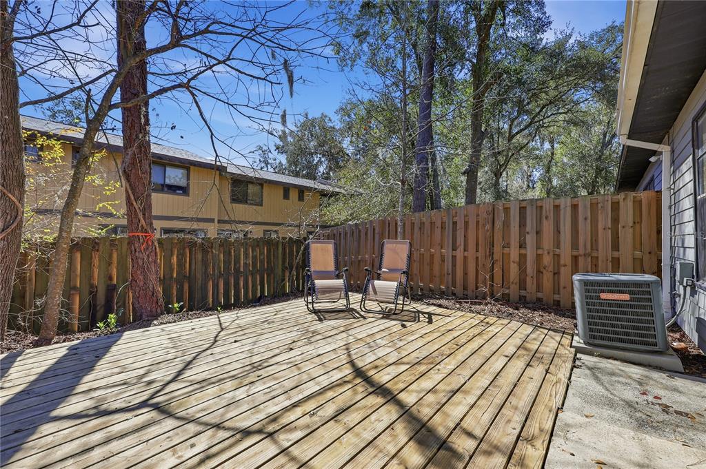 4427 Southwest 21st Lane Gainesville, FL 32607 - Photo 8 of 36 a view of a wooden deck with a house and wooden fence