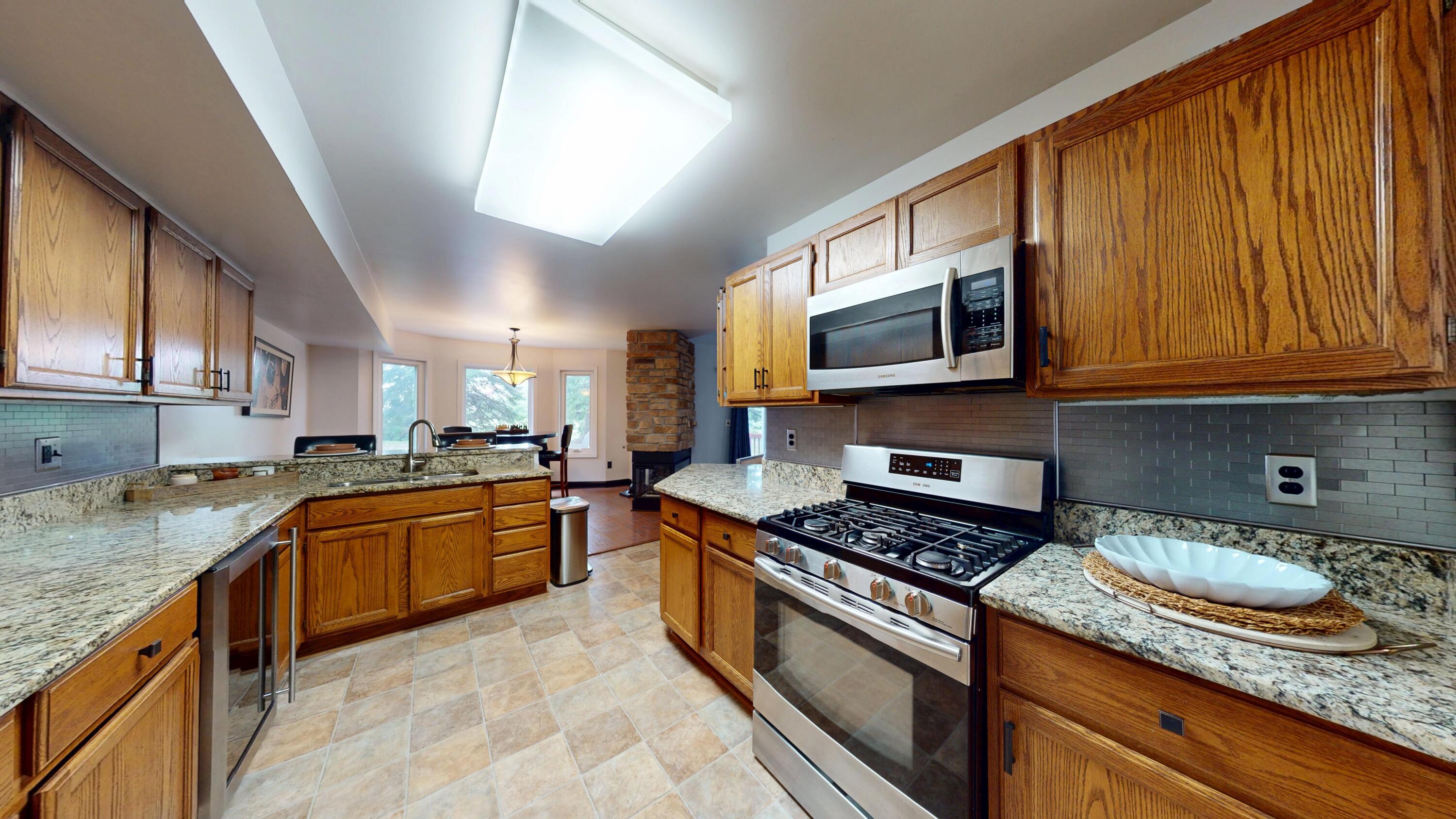 9344 Van Buren Street Crown Point, IN 46307 - Photo 13 of 37 a kitchen with granite countertop stainless steel appliances and cabinets